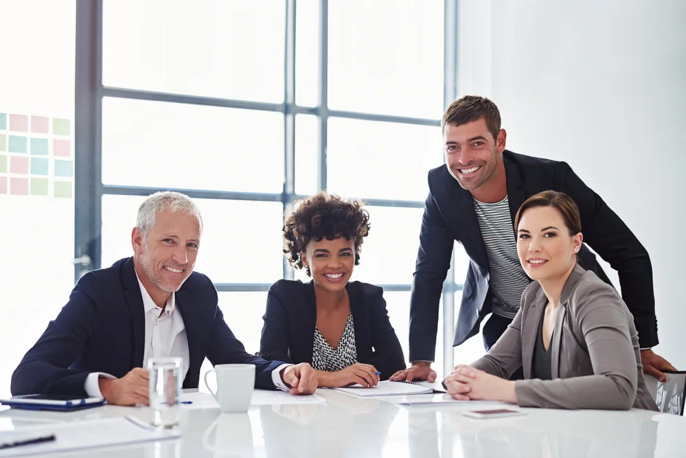 Employees smile at a code of conduct employee compliance training.