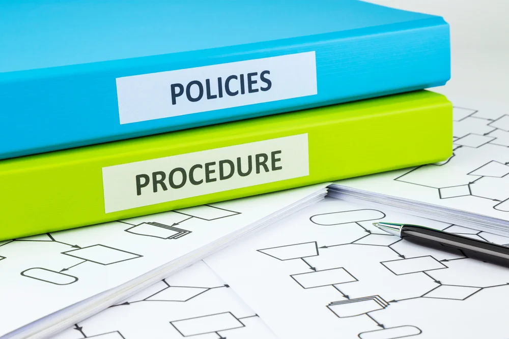 Colorful binders showing policies and procedures are 2 important aspects of the hitrust scoring rubric. 